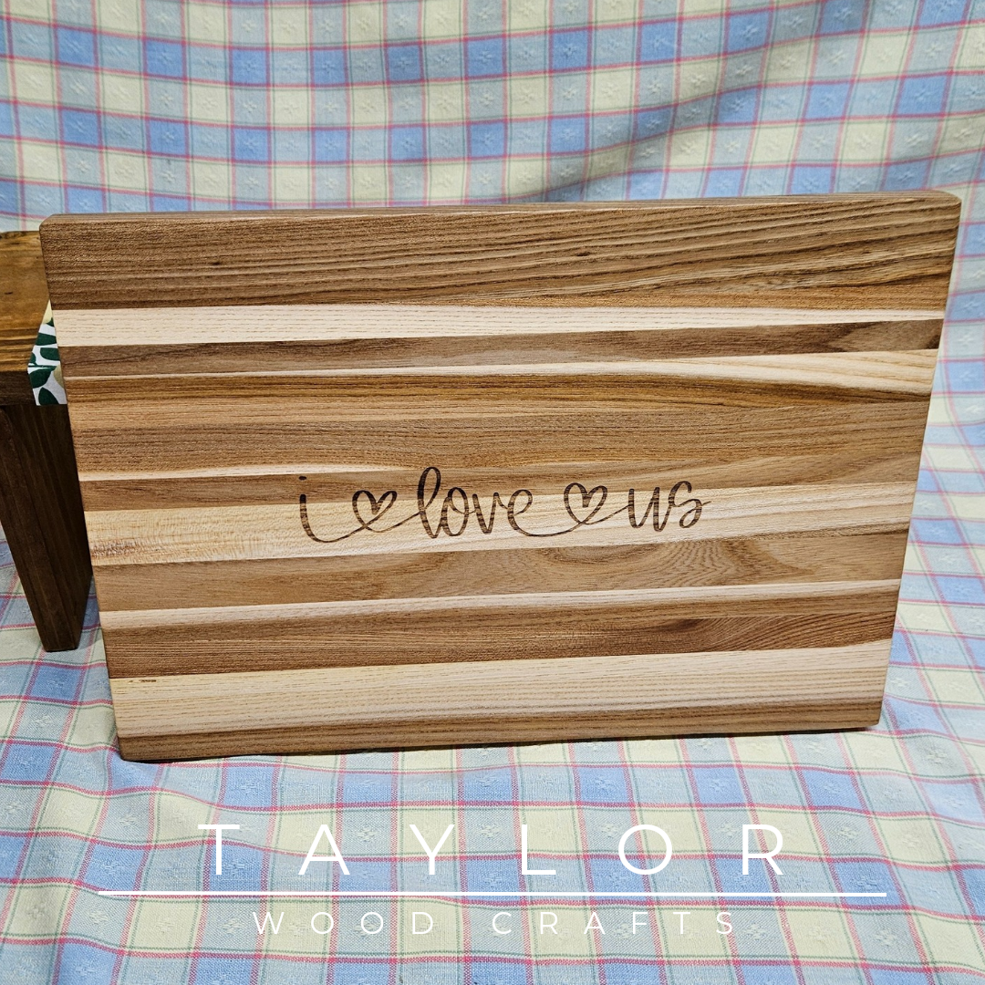 Handcrafted charcuterie board with laser engravings of love quotes, combining elegance and personal touch for serving appetizers.