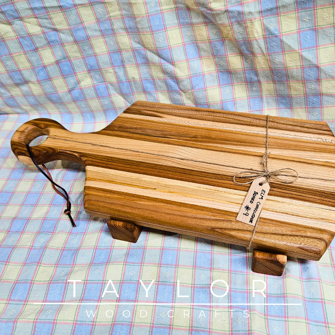 Handcrafted paddle board made from elm wood, featuring a leather string for hanging, offering durability and rustic charm.