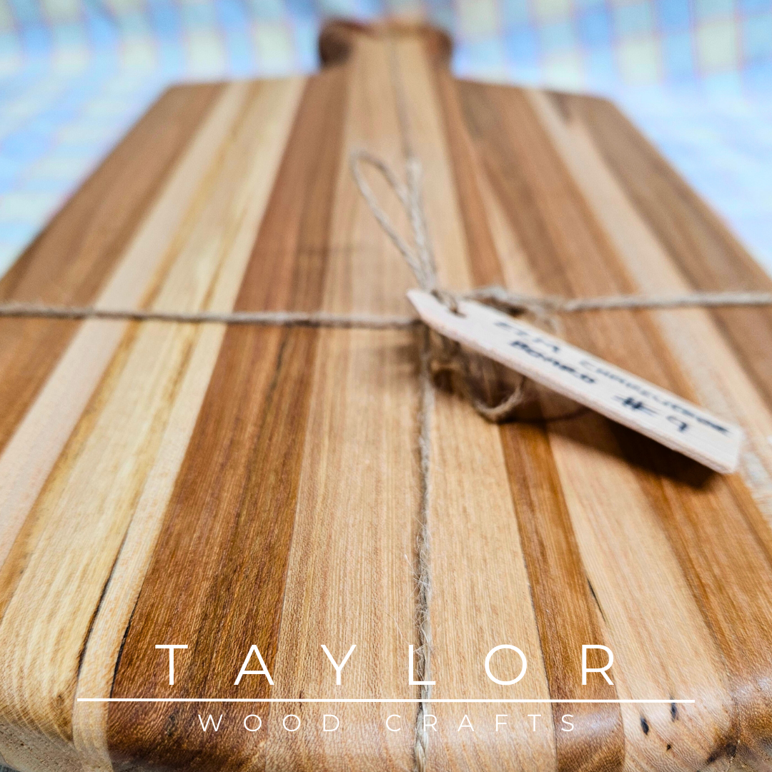 Handcrafted paddle board made from elm wood, featuring a leather string for hanging, offering durability and rustic charm.
