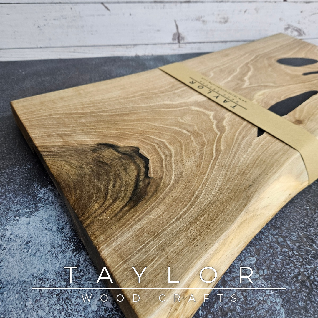Handmade European Walnut table-top chopping block with distinctive black epoxy resin details, crafted in Northern Ireland.