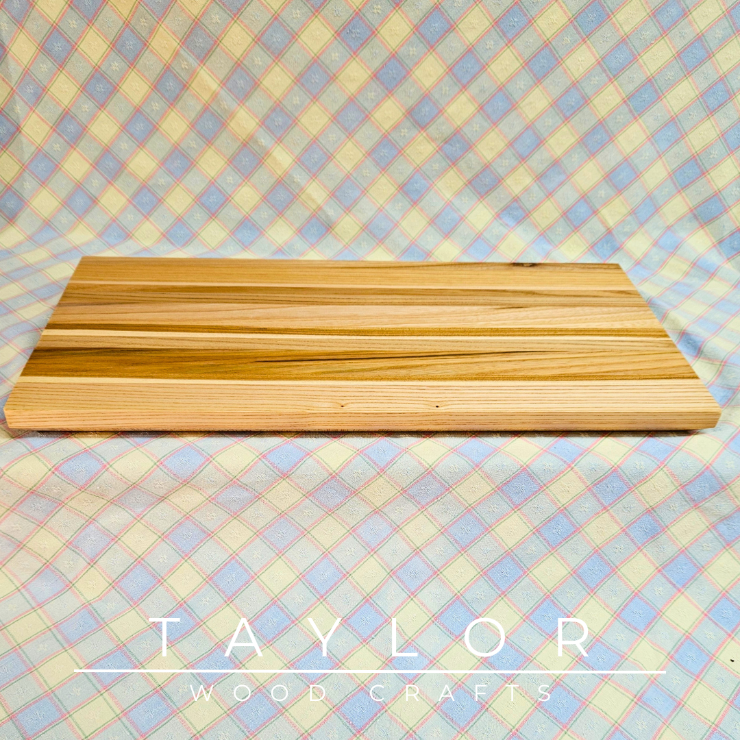 Handmade hardwood charcuterie board, crafted from locally sourced wood and finished with food-safe oils.