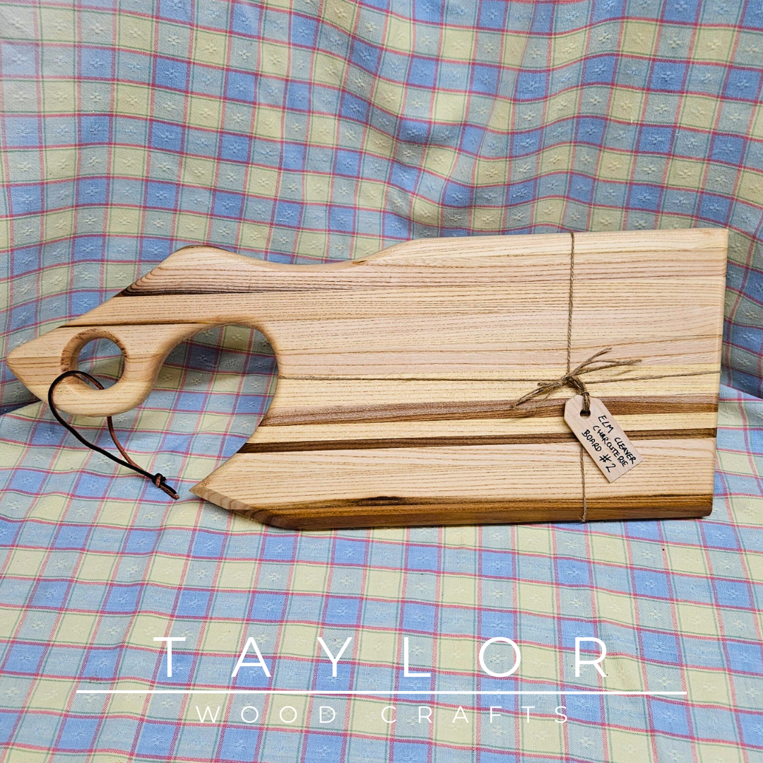 Handcrafted cleaver-shaped charcuterie board with a leather string for hanging, offering unique style and functionality for serving appetizers.