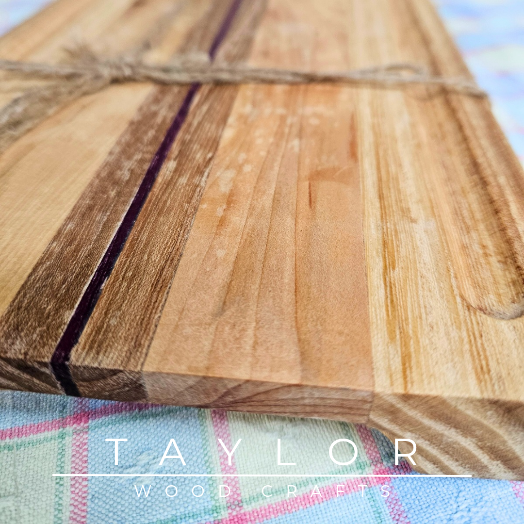 Handcrafted chopping board made from walnut, purple heart, and cedar wood, offering durability and unique style for your kitchen.