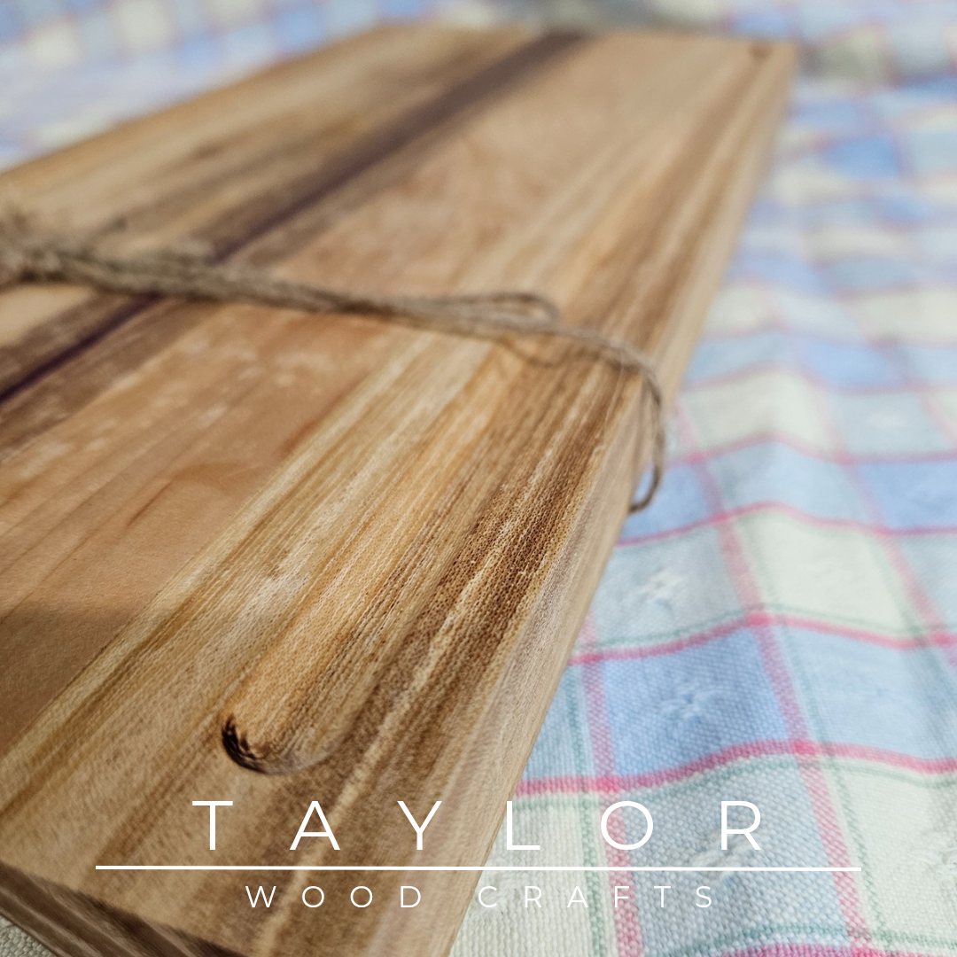 Handcrafted chopping board made from walnut, purple heart, and cedar wood, offering durability and unique style for your kitchen.