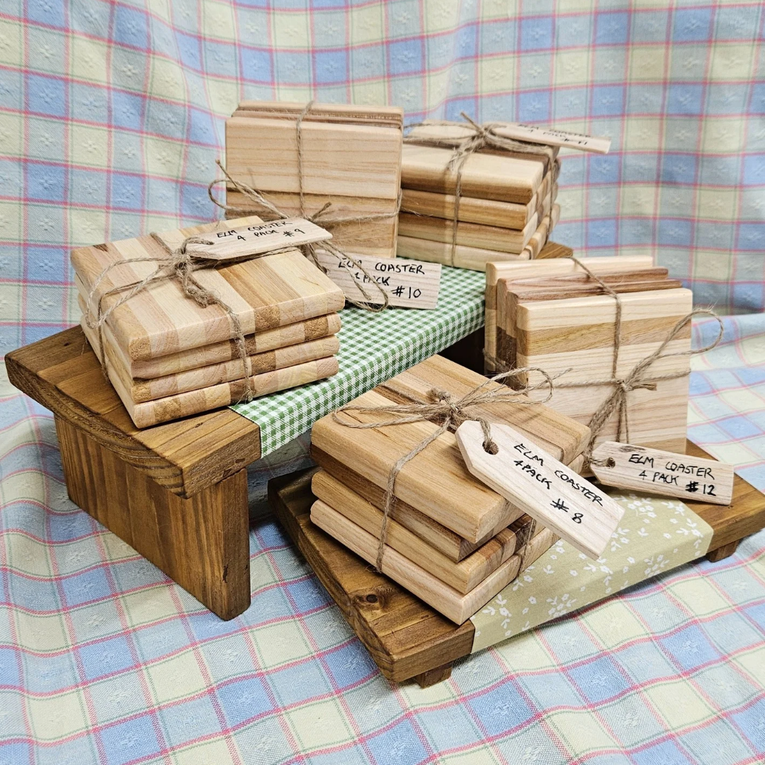 Handcrafted elm wood four coaster pack, offering natural elegance and durability to protect your surfaces in style.