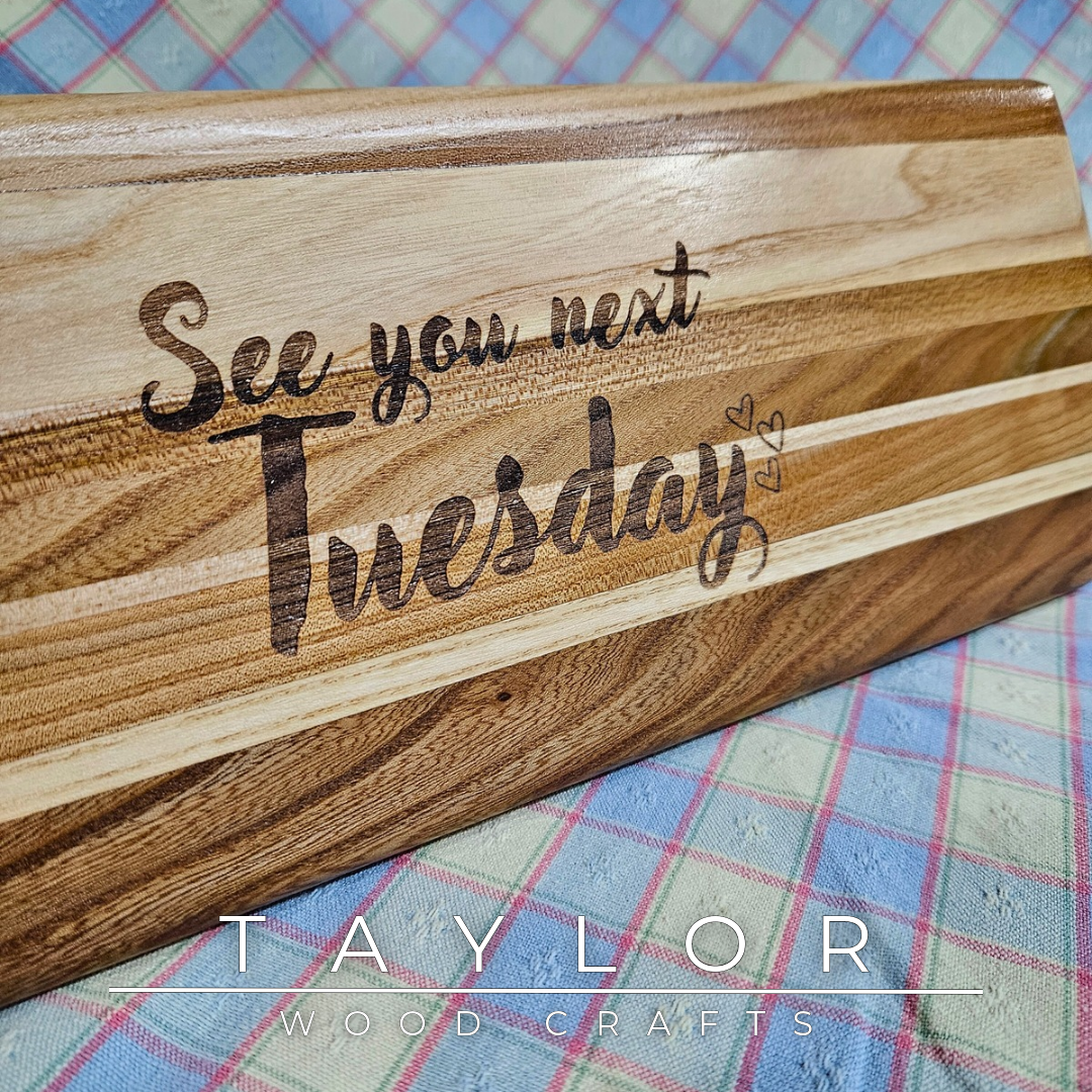 Handcrafted elm wood charcuterie board shaped like a paddle, showcasing rich wood grain for a rustic and elegant touch.