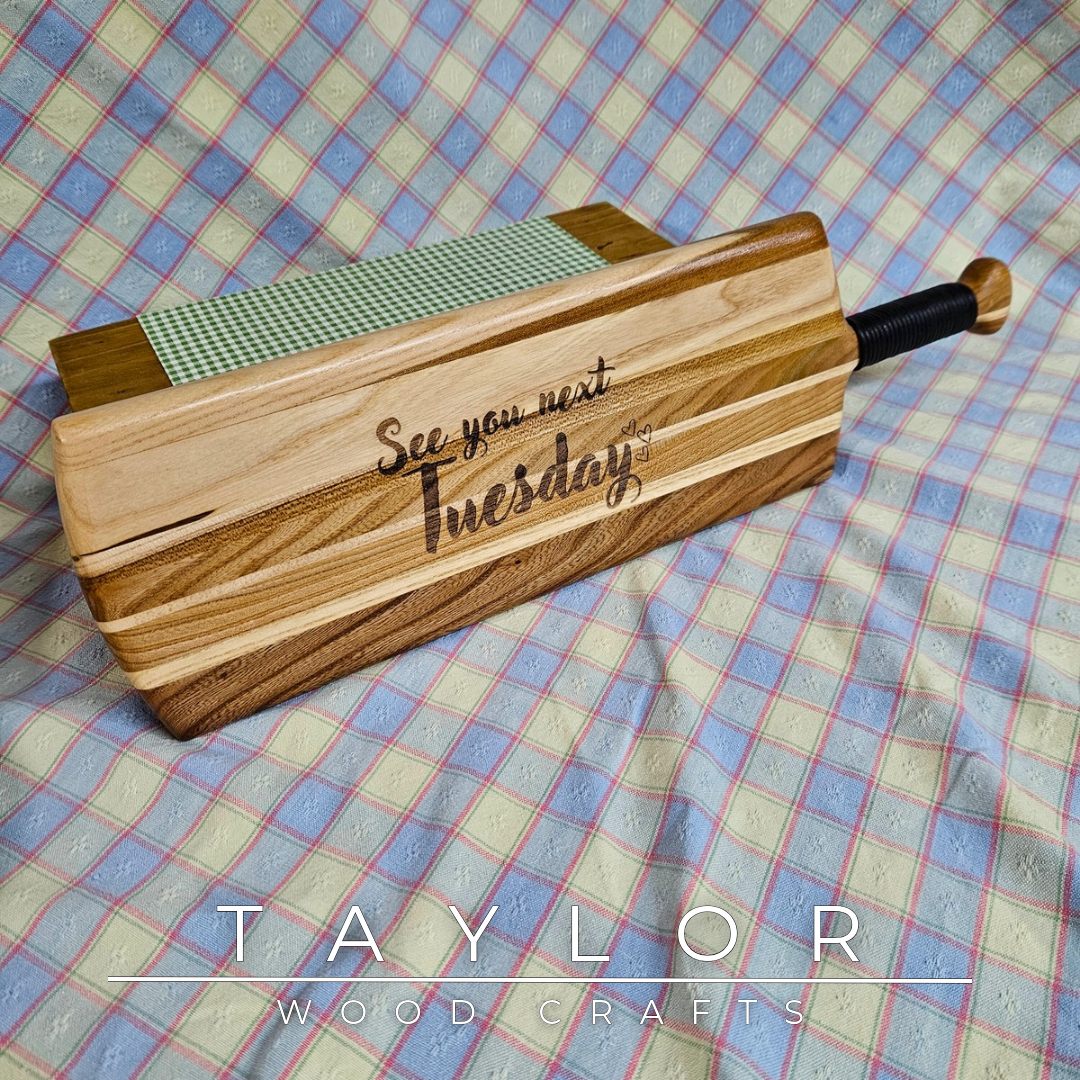Handcrafted elm wood charcuterie board shaped like a paddle, showcasing rich wood grain for a rustic and elegant touch.