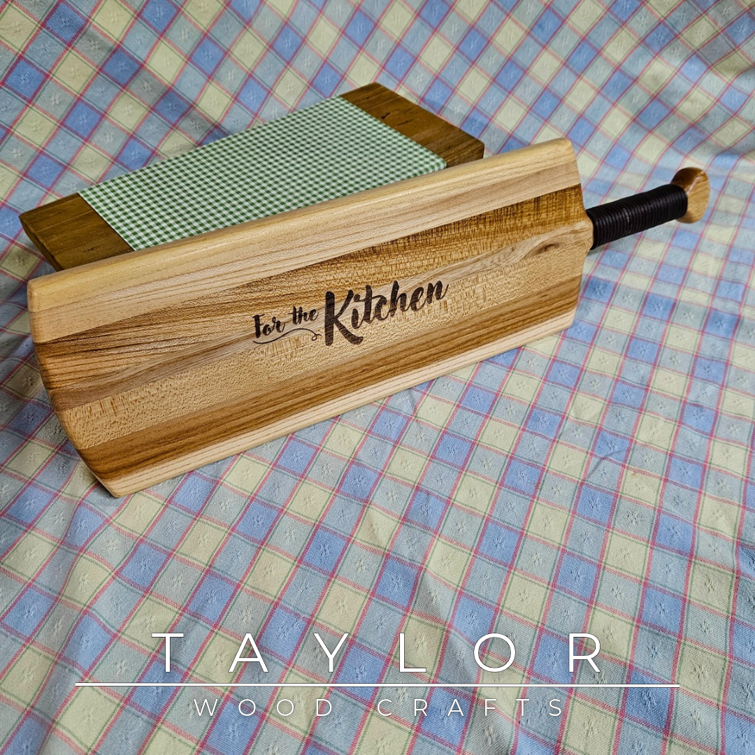 Handcrafted elm wood charcuterie board shaped like a paddle, showcasing rich wood grain for a rustic and elegant touch.