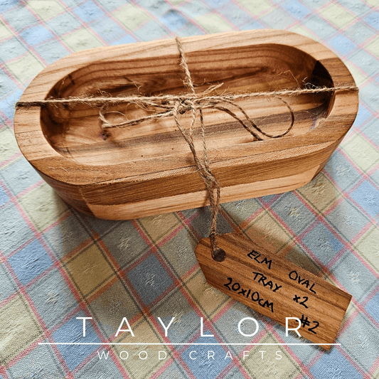 Handcrafted set of 2 oval dishes made from elm wood, offering natural elegance and durability for serving food in style.