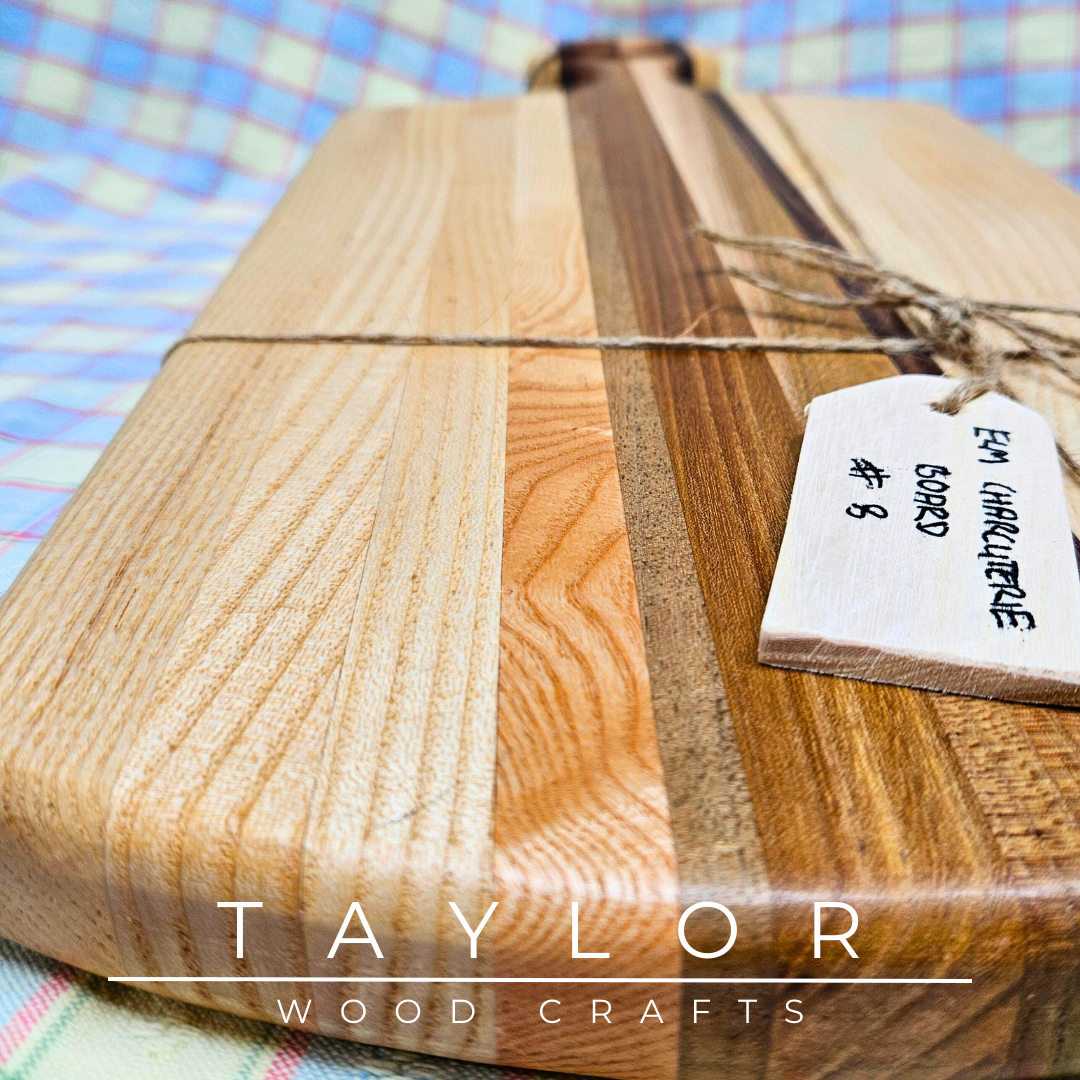 Handcrafted paddle board made with elm, ash, and walnut, featuring a leather string for hanging, combining durability and rustic style.