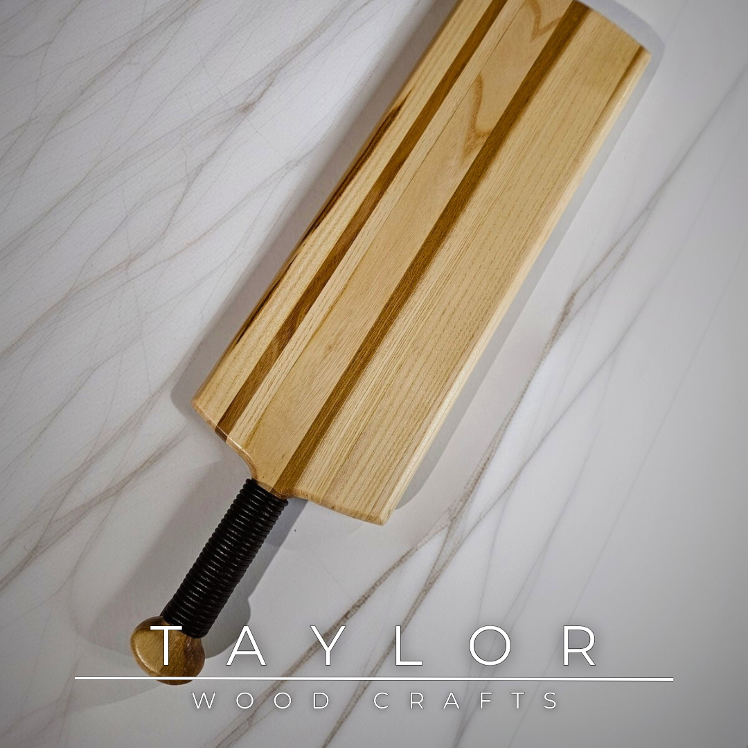 Charcuterie board shaped like a paddle board, made from quality wood with rich grain, perfect for serving snacks and appetizers.