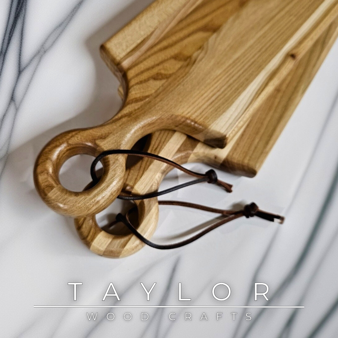 Charcuterie board shaped like a paddle board, made from quality wood with rich grain, perfect for serving snacks and appetizers.