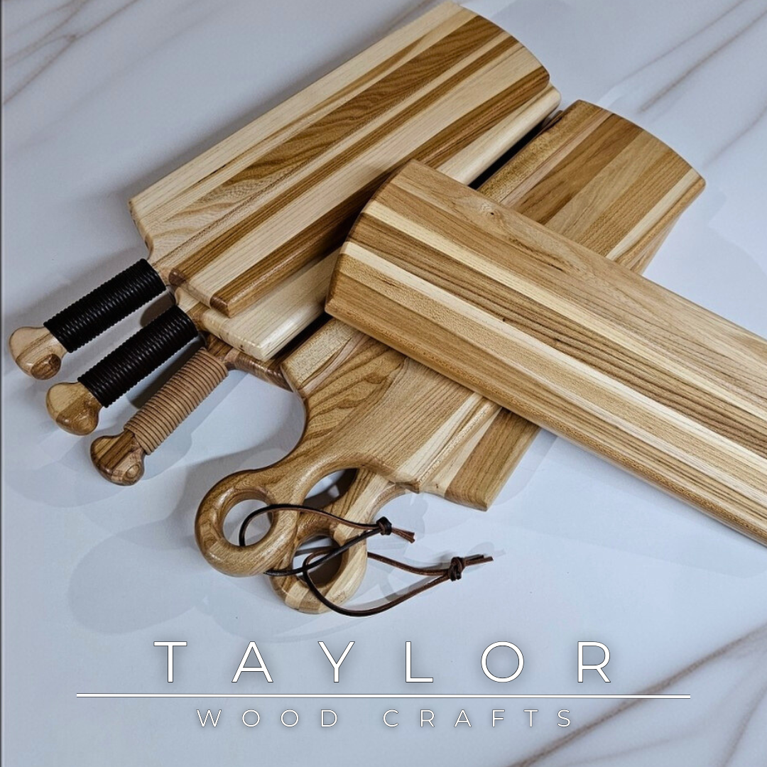Charcuterie board shaped like a paddle board, made from quality wood with rich grain, perfect for serving snacks and appetizers.