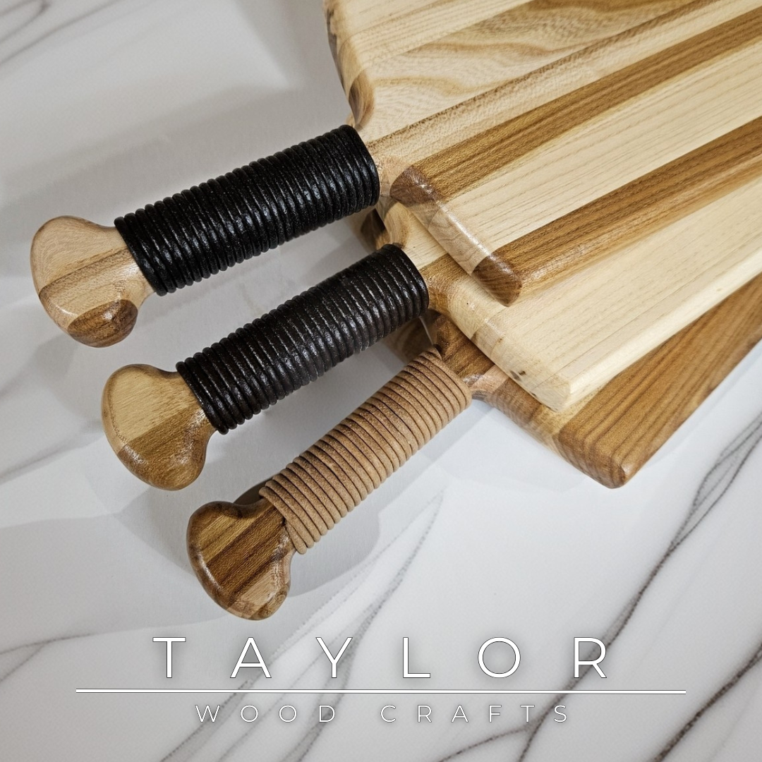 Charcuterie board shaped like a paddle board, made from quality wood with rich grain, perfect for serving snacks and appetizers.
