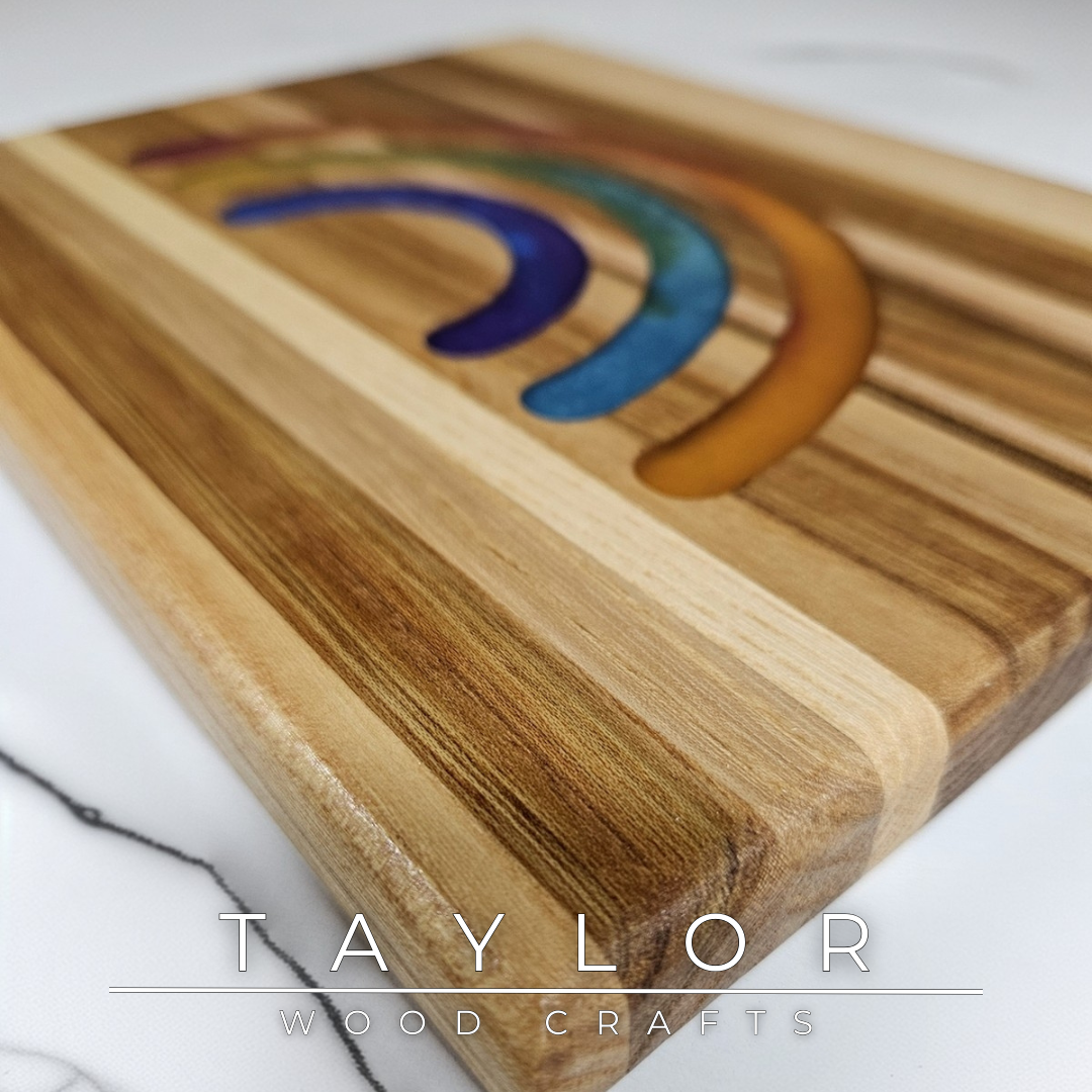 This handcrafted trivet pairs natural wood with a bold rainbow epoxy insert, creating a one-of-a-kind blend of function and color. Designed as a stylish worktop protector, it keeps your surfaces safe while adding a splash of personality. Durable and full of charm, it’s a fun, practical addition to any kitchen or dining table.