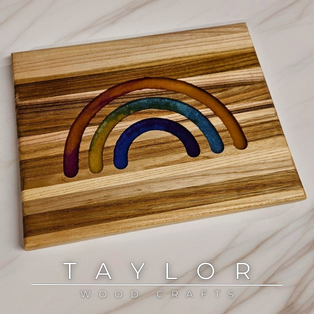 This handcrafted trivet pairs natural wood with a bold rainbow epoxy insert, creating a one-of-a-kind blend of function and color. Designed as a stylish worktop protector, it keeps your surfaces safe while adding a splash of personality. Durable and full of charm, it’s a fun, practical addition to any kitchen or dining table.


