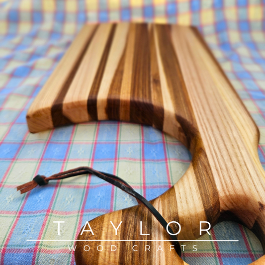 Handcrafted charcuterie board with a swan neck handle and leather string, combining elegance and functionality for serving in style.