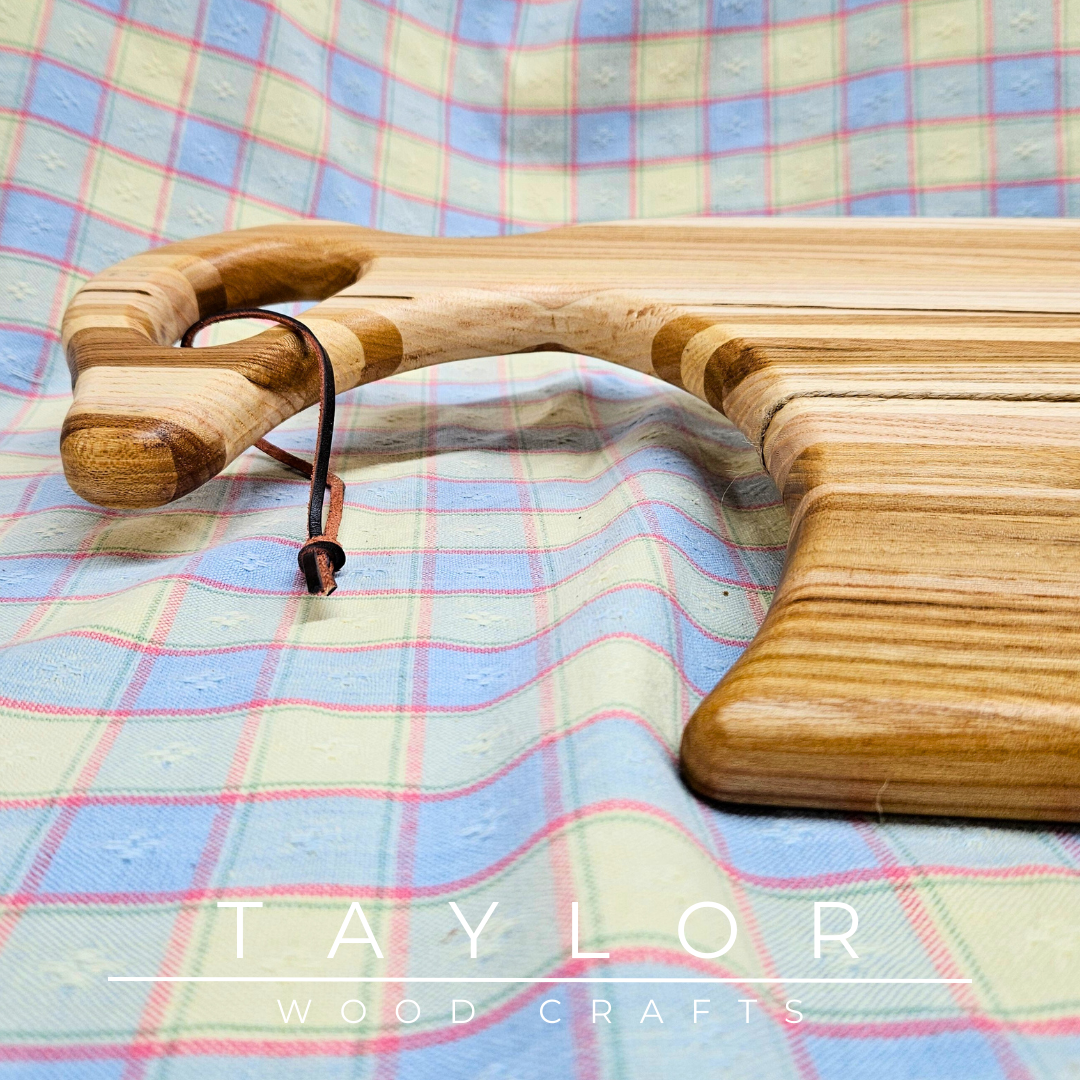 Handcrafted charcuterie board with a swan neck handle and leather string, combining elegance and functionality for serving in style.