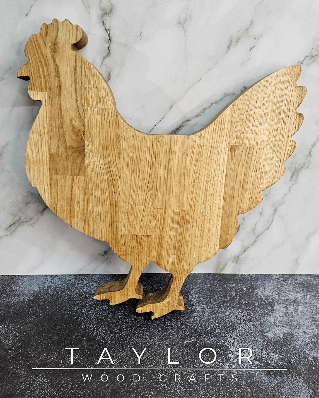 Wooden rooster cutting board on a marble surface with 'Taylor Wood Crafts' branding.