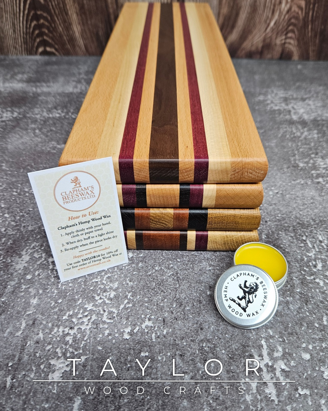Wooden cutting board with a card and container on a gray surface, featuring 'Taylor Wood Crafts' branding.