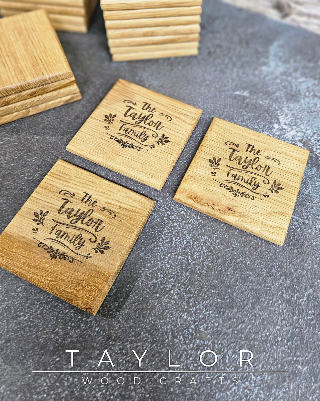 Wooden coasters with 'The Taylor Family' engraving on a gray surface, branded 'Taylor Wood Crafts'.