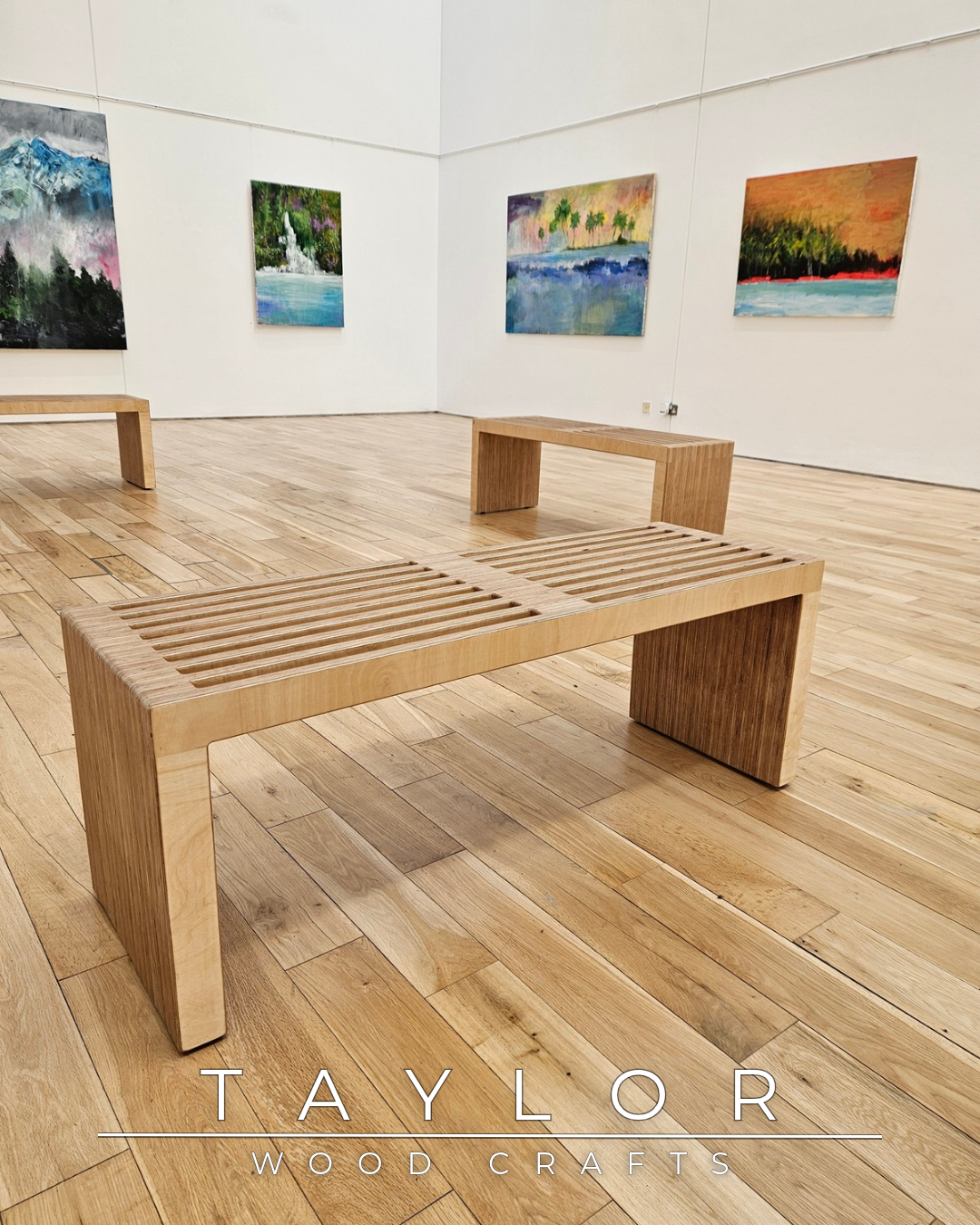 Wooden bench in a room with artworks on the walls, featuring the brand 'Taylor Wood Crafts'.