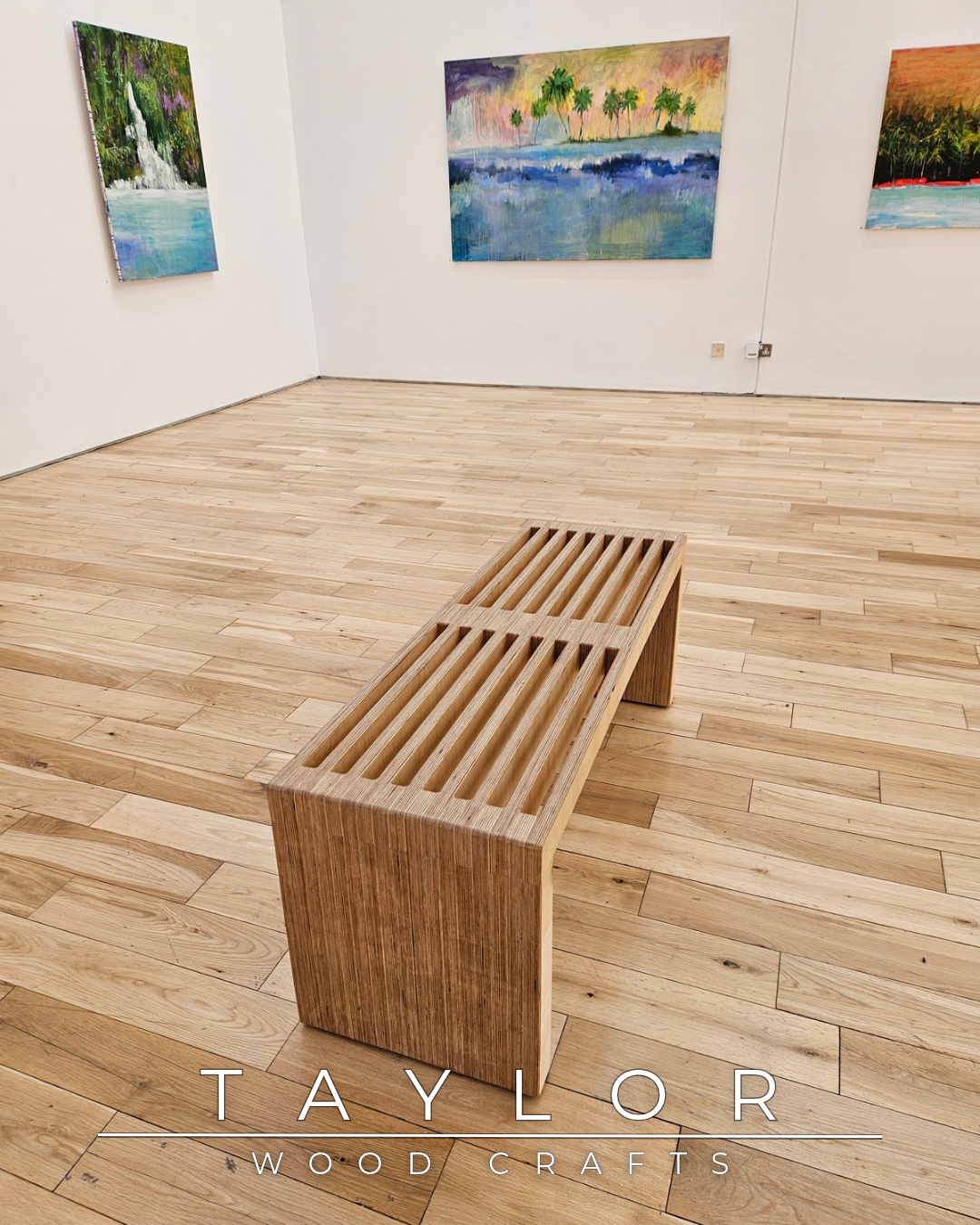 Wooden bench in a room with wooden flooring and wall art, featuring 'Taylor Wood Crafts' branding.