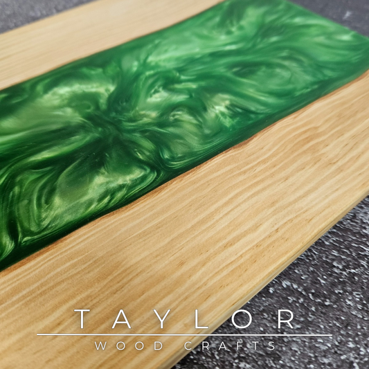 Wooden cutting board with green resin inlay on a dark surface, featuring 'Taylor Wood Crafts' branding.