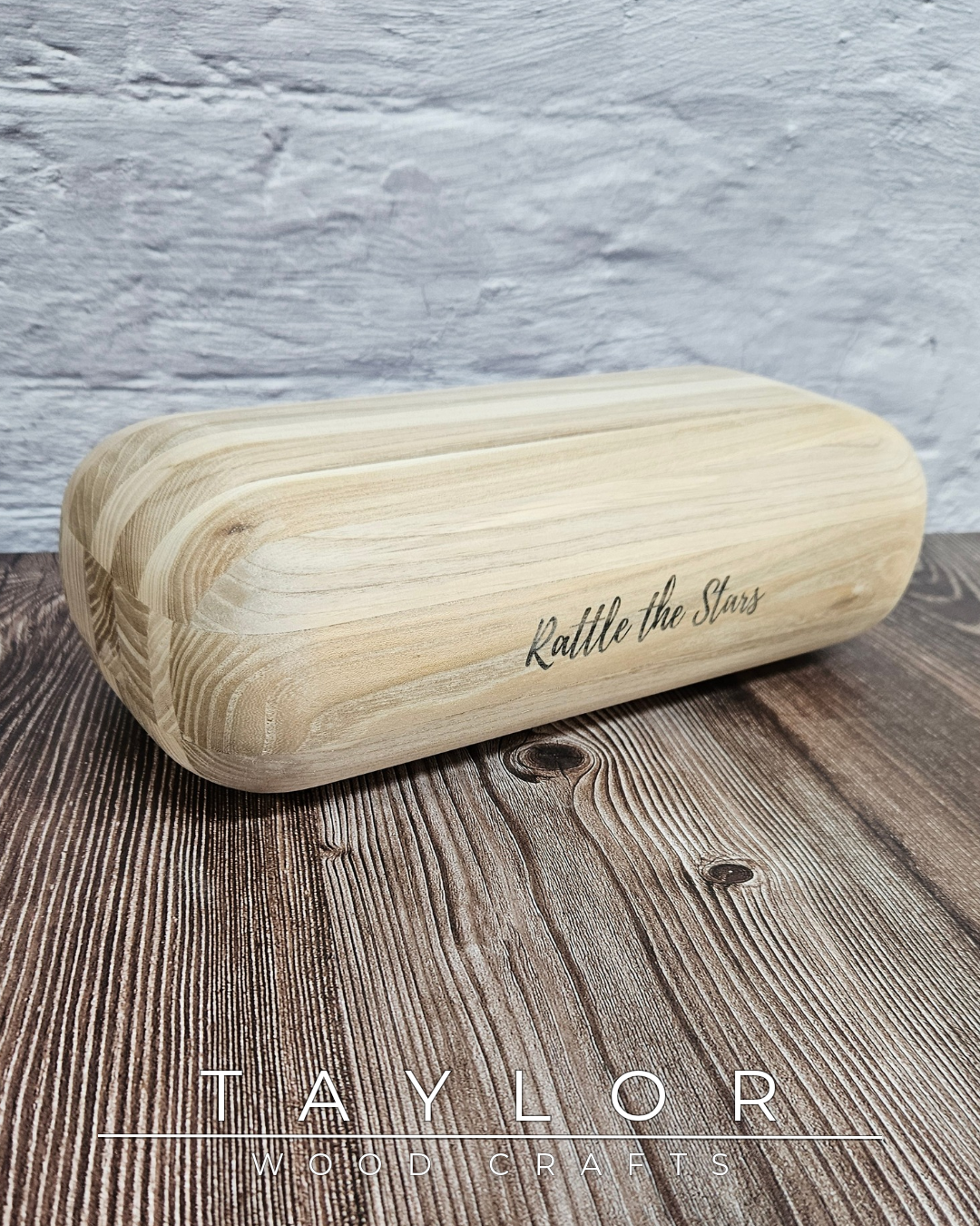 Wooden roller with 'Rattle the Stars' engraving on a wooden surface, branded 'Taylor Wood Crafts'.