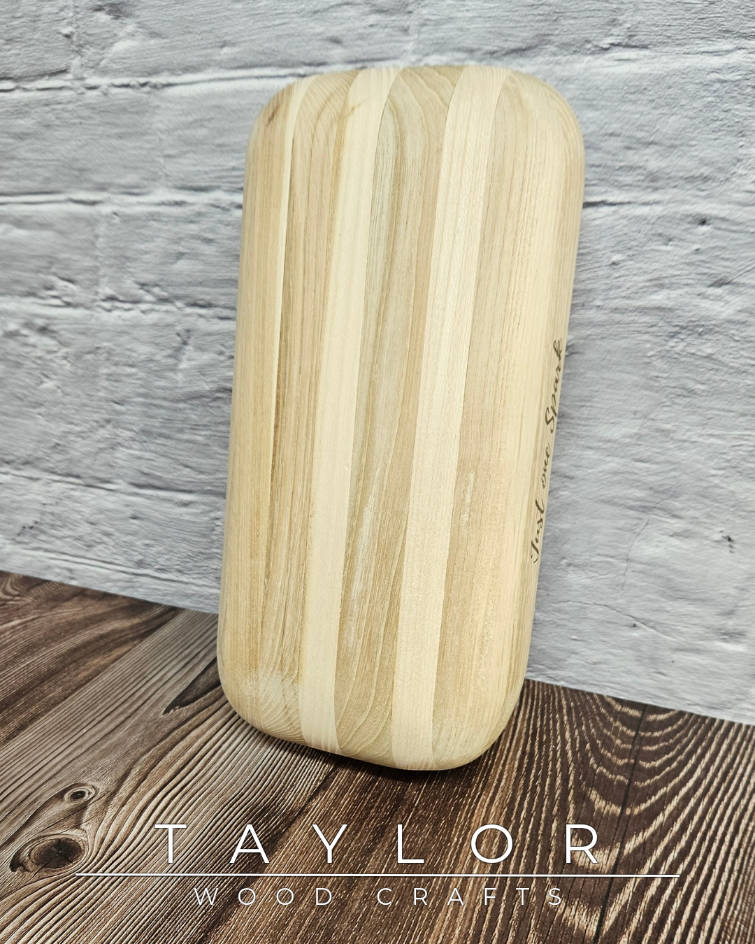 Wooden cutting board with 'Taylor Wood Crafts' branding on a wooden surface.