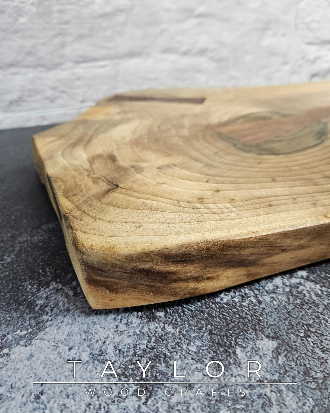 Handcrafted live edge walnut chopping block by Taylor Wood Crafts. Made from premium solid walnut, each board is one of a kind — perfect for cooking, serving, or display.