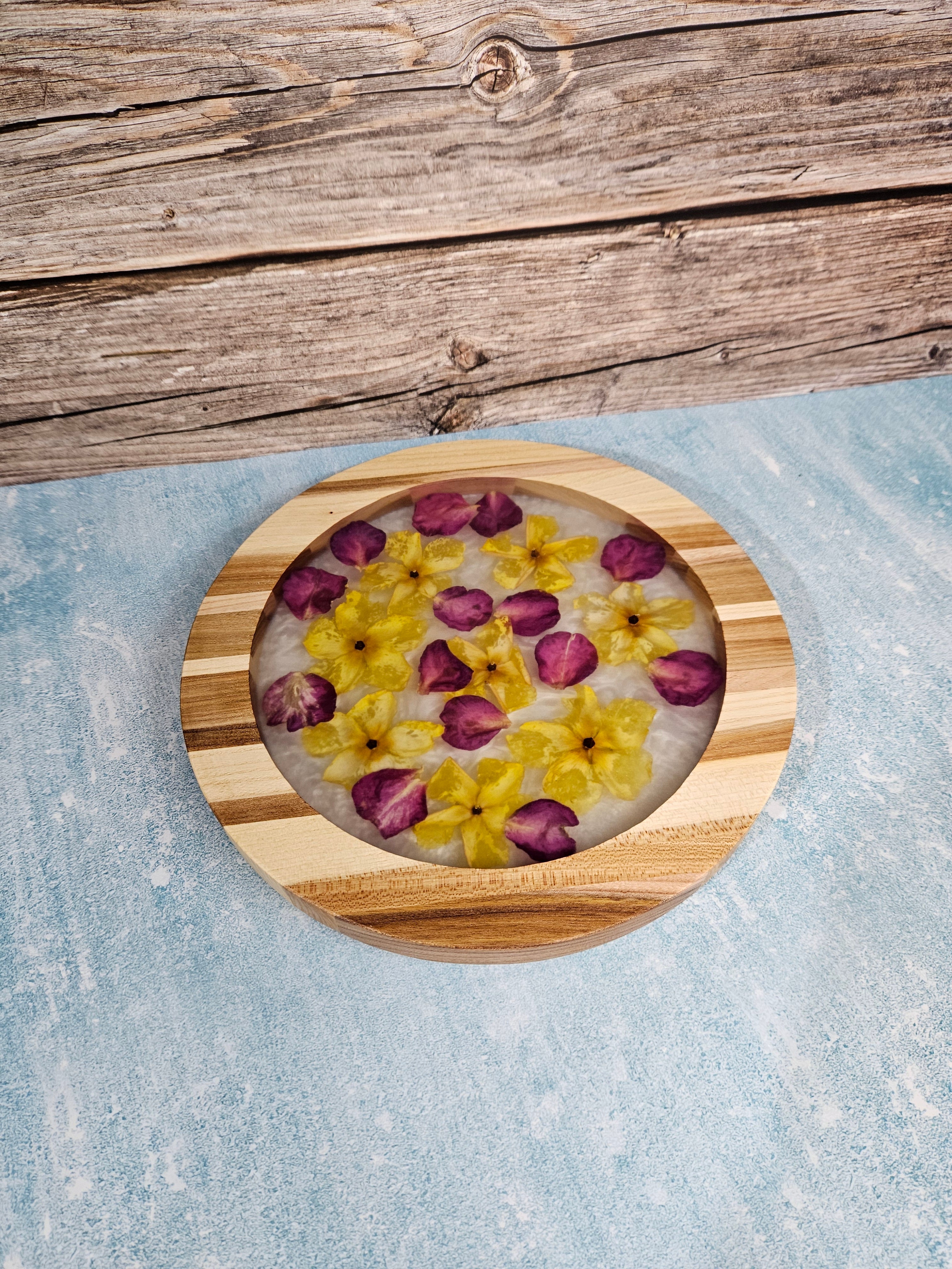 Handcrafted elm centerpiece by Taylor Wood Crafts featuring a resin core with preserved yellow and red flowers for a unique natural display.