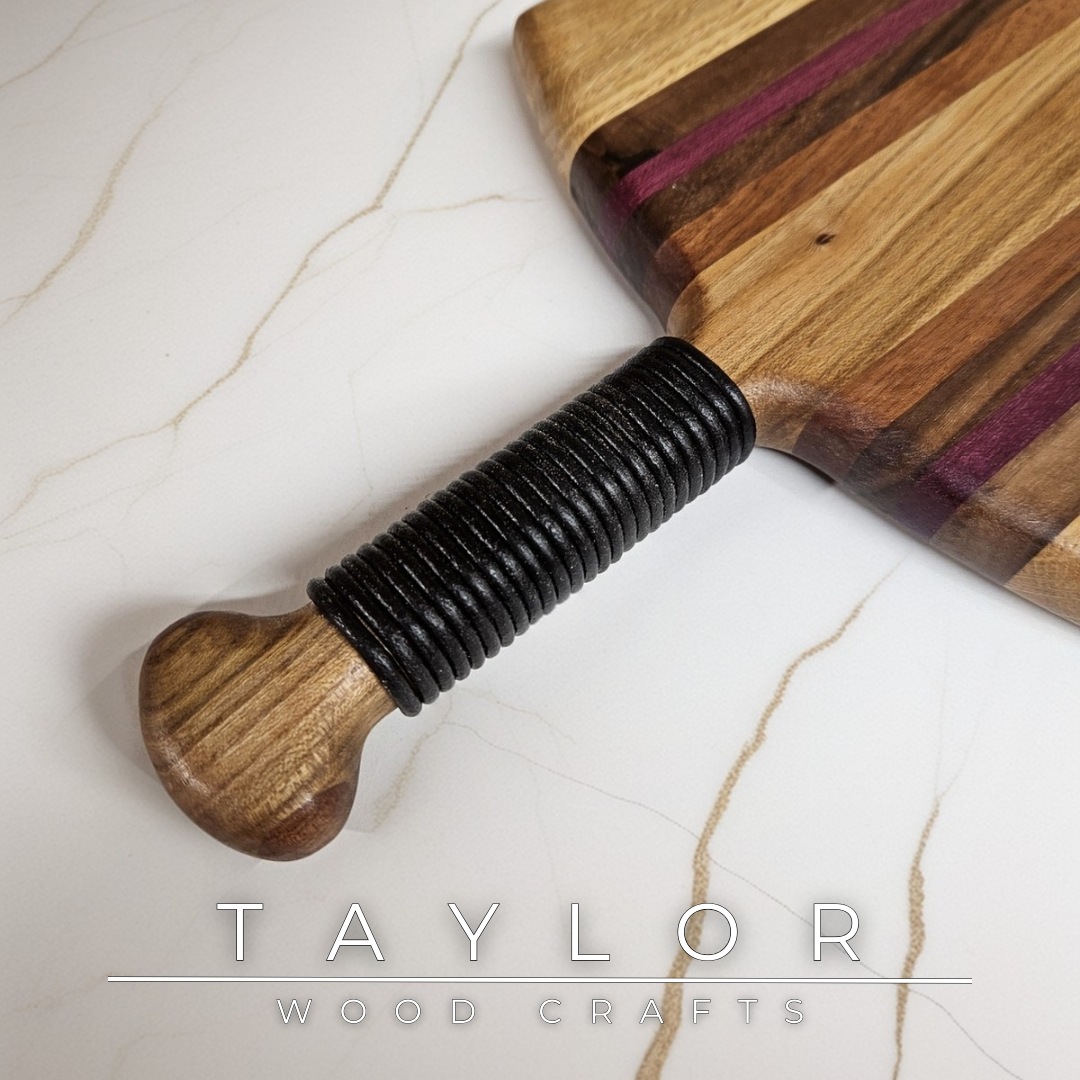 Unique charcuterie board by Taylor Wood Crafts, made from mixed hardwoods with a leather-wrapped handle.
