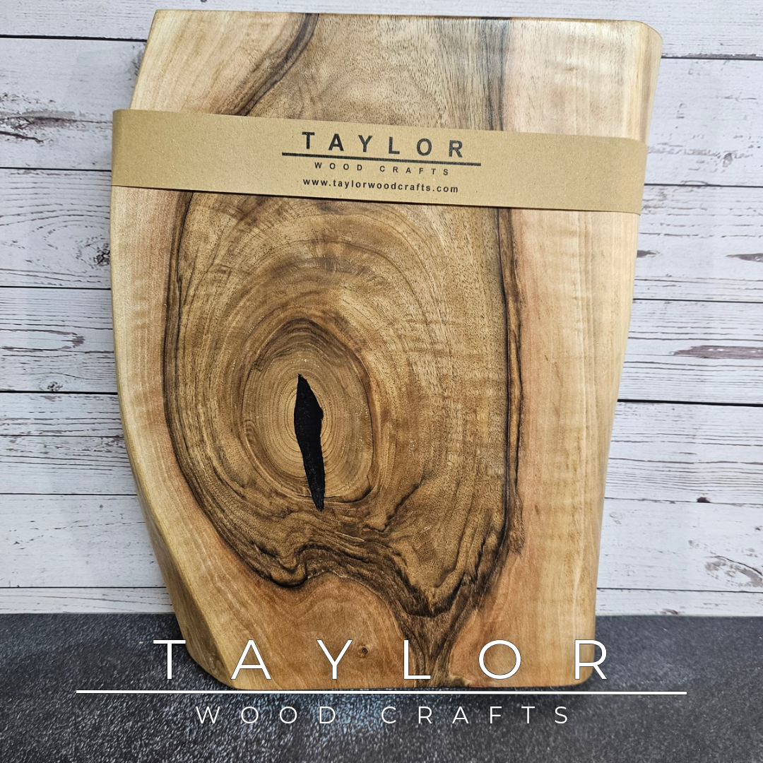 Handmade European Walnut table-top chopping block with distinctive black epoxy resin details, crafted in Northern Ireland.