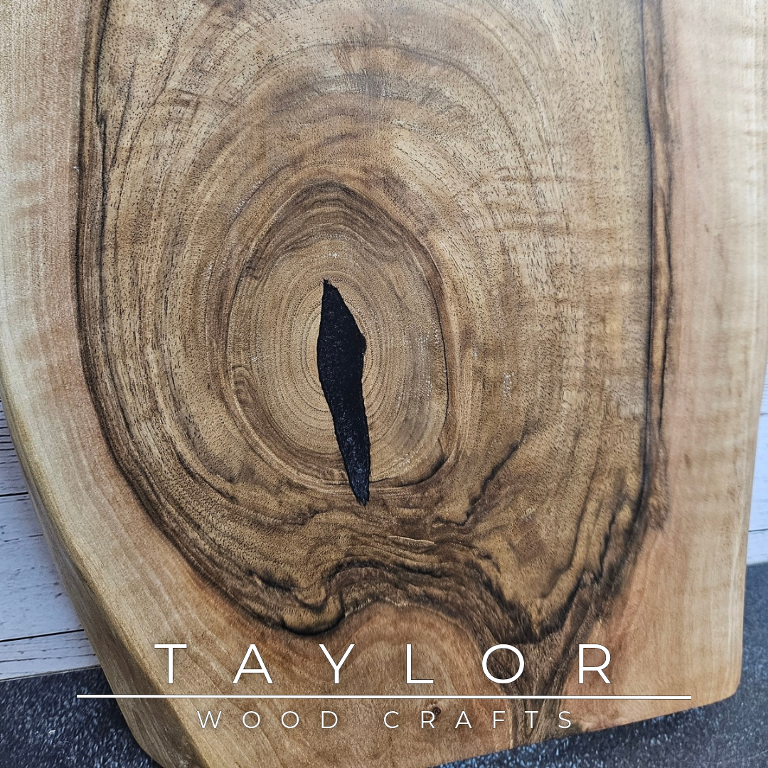 Handmade European Walnut table-top chopping block with distinctive black epoxy resin details, crafted in Northern Ireland.