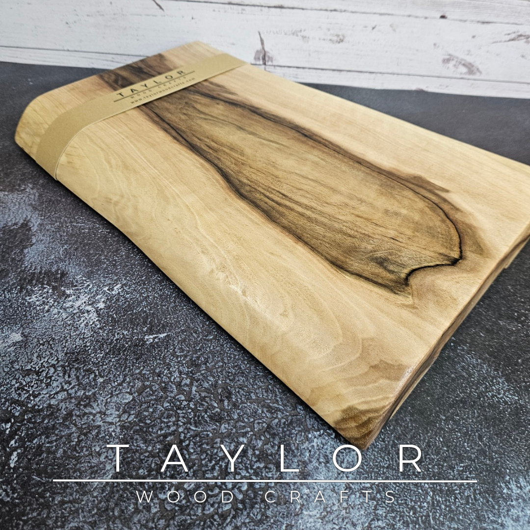 Handmade European Walnut table-top chopping block with distinctive black epoxy resin details, crafted in Northern Ireland.