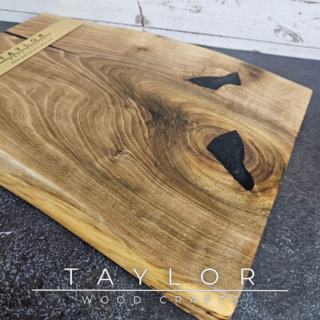 Handmade European Walnut table-top chopping block with distinctive black epoxy resin details, crafted in Northern Ireland.