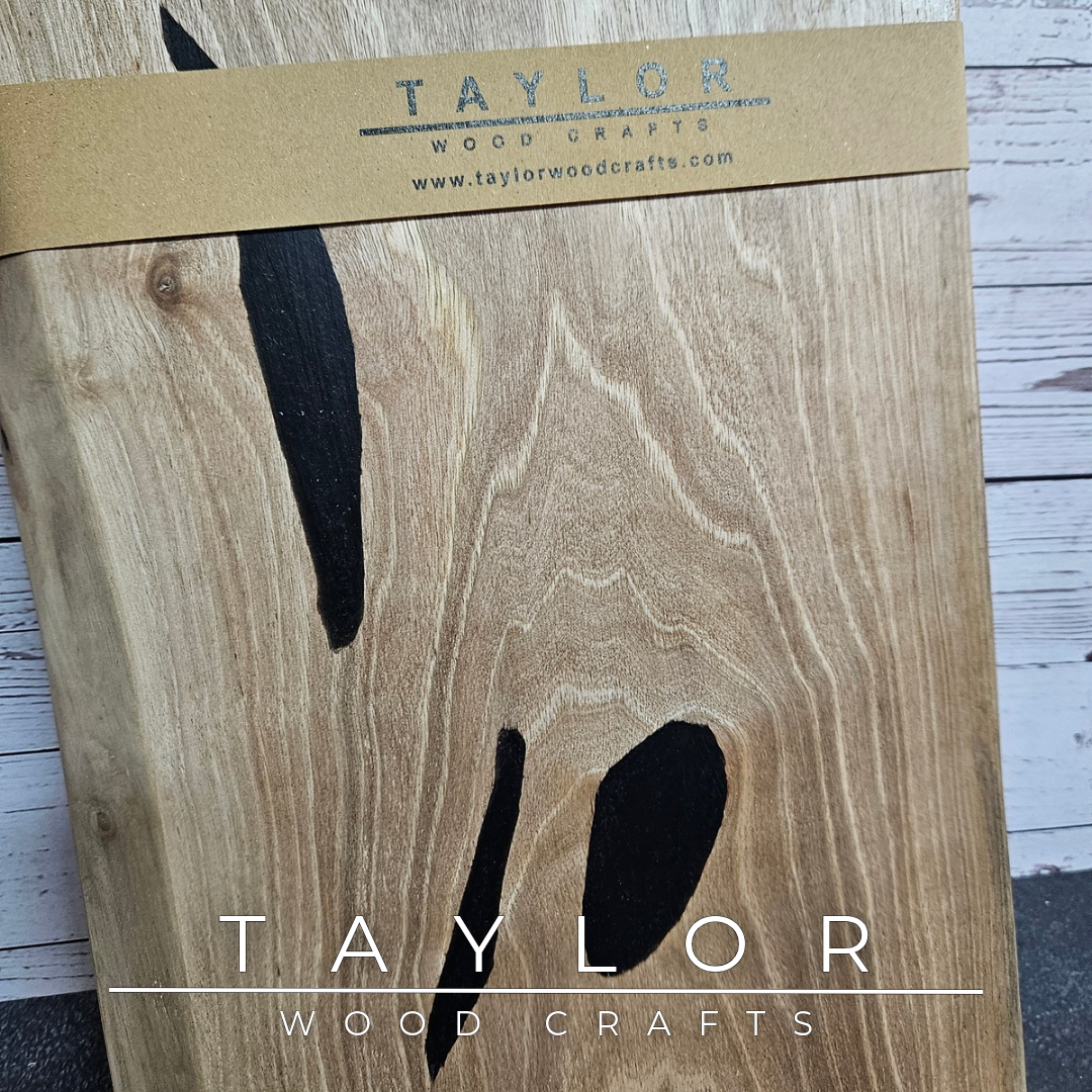 Handmade European Walnut table-top chopping block with distinctive black epoxy resin details, crafted in Northern Ireland.