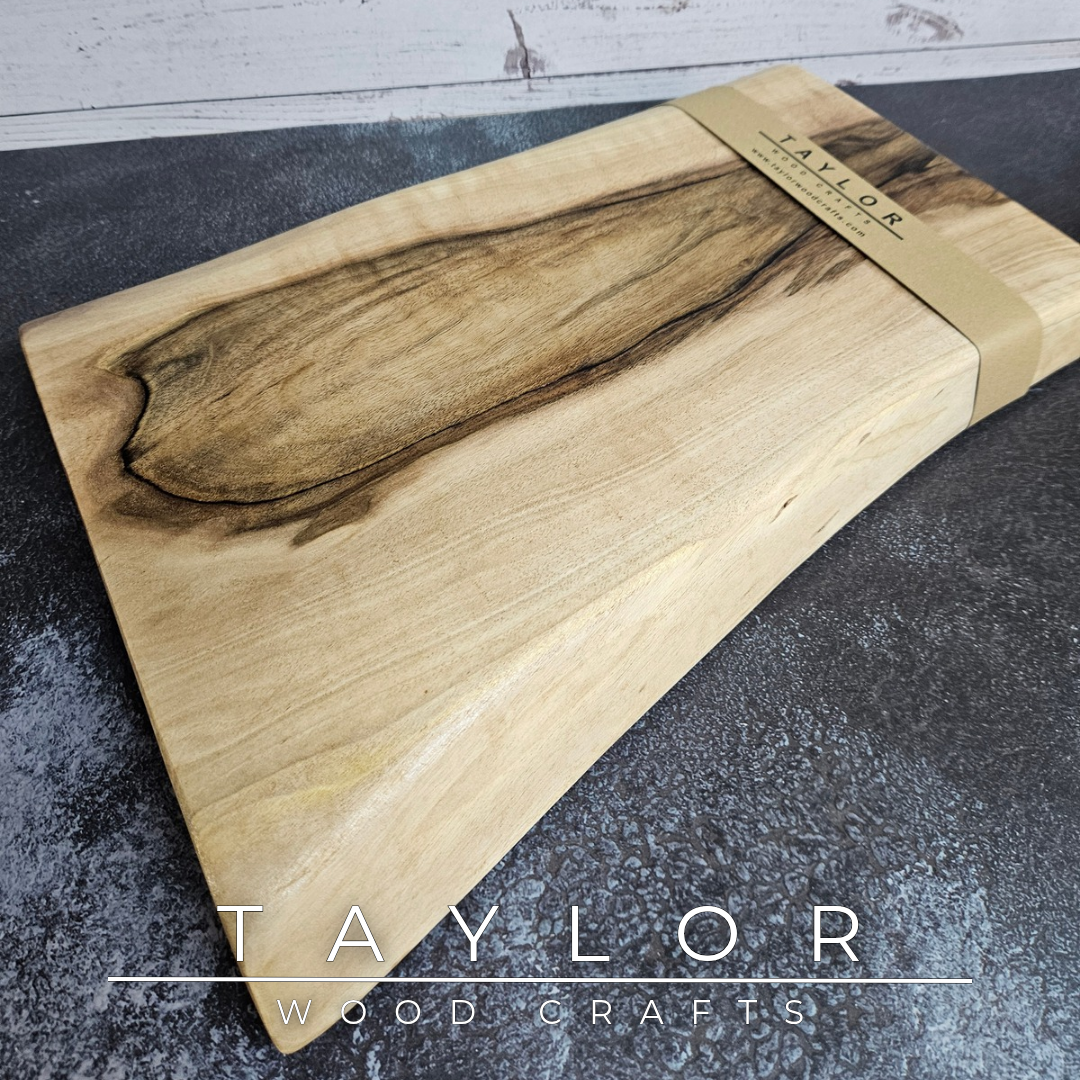 Handmade European Walnut table-top chopping block with distinctive black epoxy resin details, crafted in Northern Ireland.