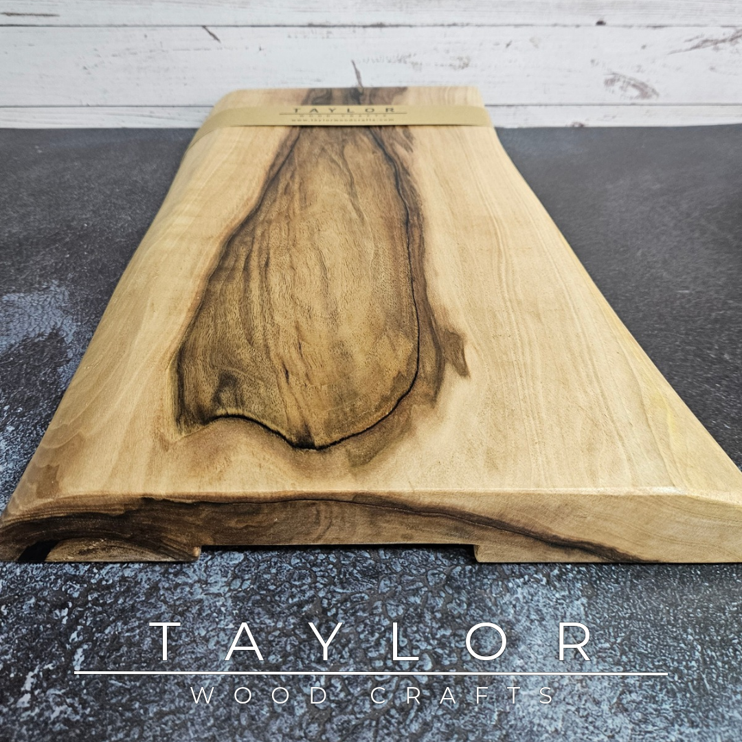 Handmade European Walnut table-top chopping block with distinctive black epoxy resin details, crafted in Northern Ireland.