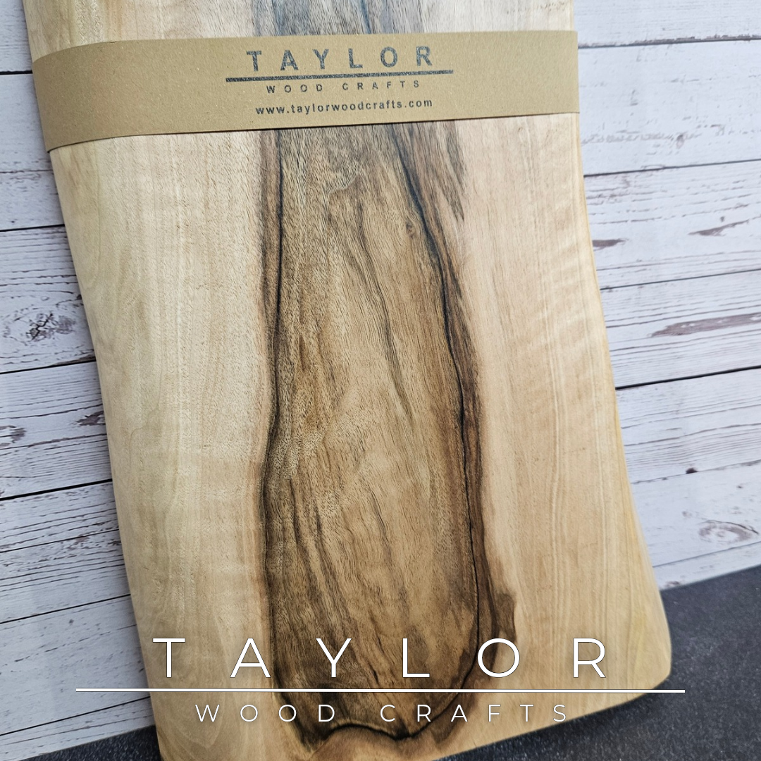 Handmade European Walnut table-top chopping block with distinctive black epoxy resin details, crafted in Northern Ireland.