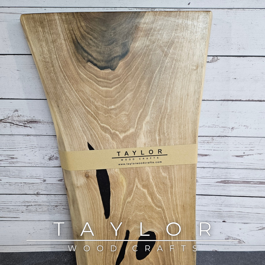 Handmade European Walnut table-top chopping block with distinctive black epoxy resin details, crafted in Northern Ireland.