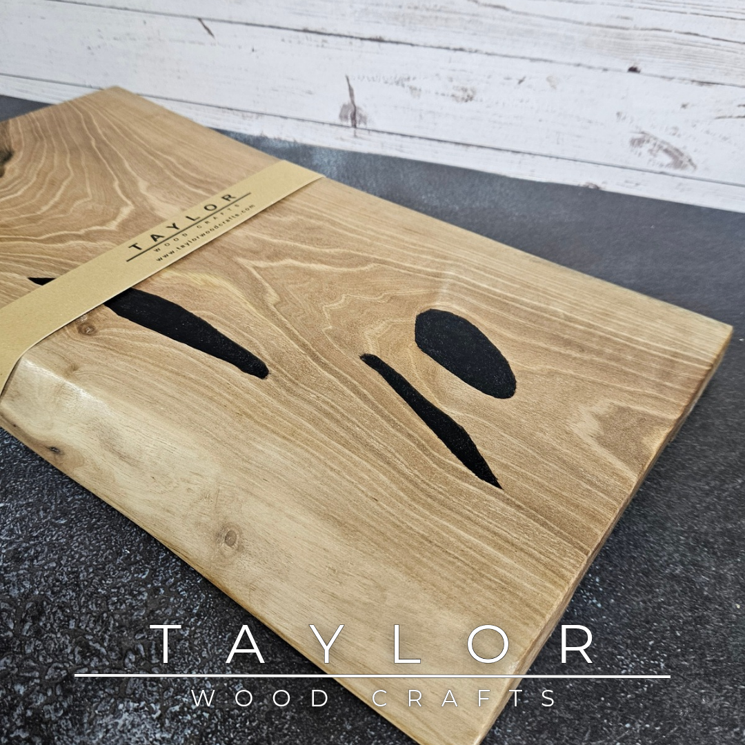 Handmade European Walnut table-top chopping block with distinctive black epoxy resin details, crafted in Northern Ireland.