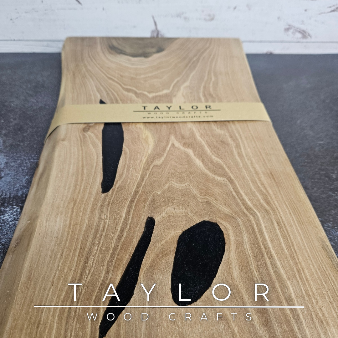 Handmade European Walnut table-top chopping block with distinctive black epoxy resin details, crafted in Northern Ireland.