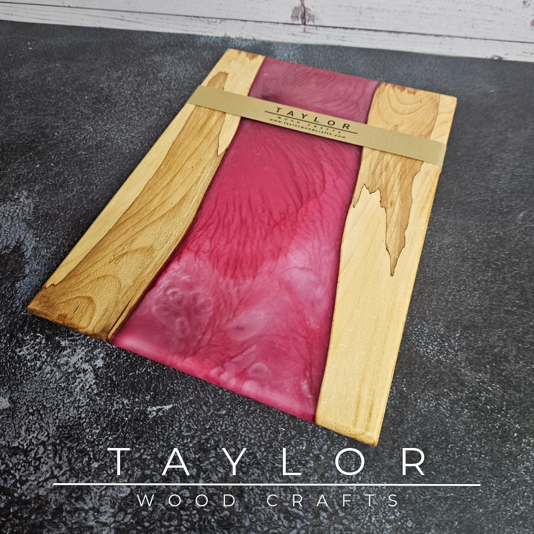 Handmade epoxy resin river charcuterie boards combining natural hardwood with striking resin designs, crafted in Northern Ireland for serving food and entertaining guests.