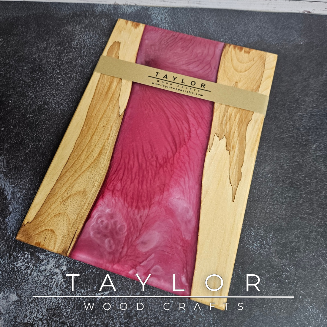 Handmade epoxy resin river charcuterie boards combining natural hardwood with striking resin designs, crafted in Northern Ireland for serving food and entertaining guests.