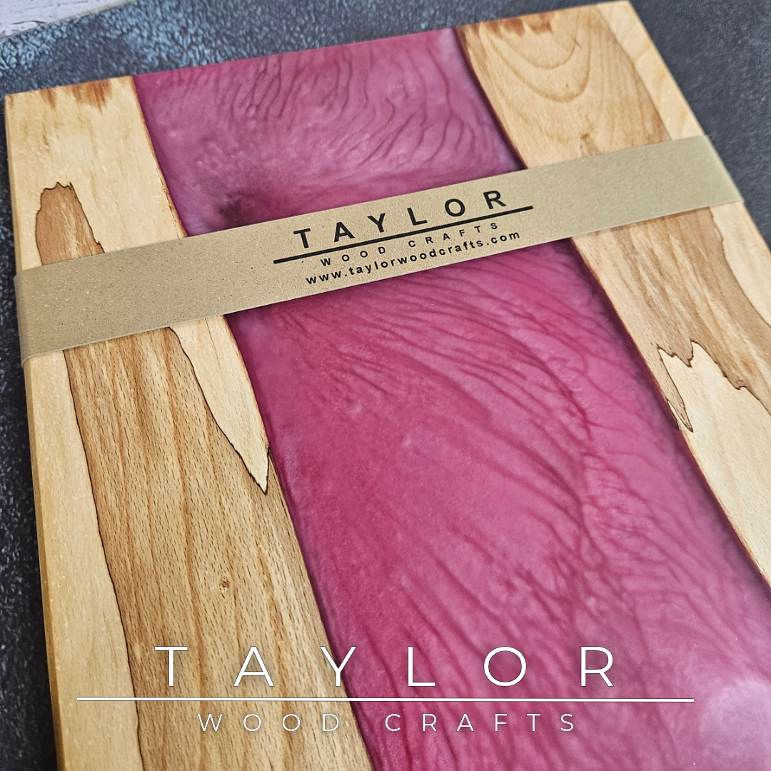 Handmade epoxy resin river charcuterie boards combining natural hardwood with striking resin designs, crafted in Northern Ireland for serving food and entertaining guests.