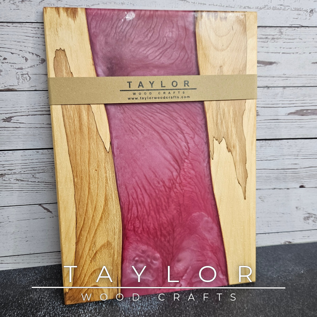 Handmade epoxy resin river charcuterie boards combining natural hardwood with striking resin designs, crafted in Northern Ireland for serving food and entertaining guests.