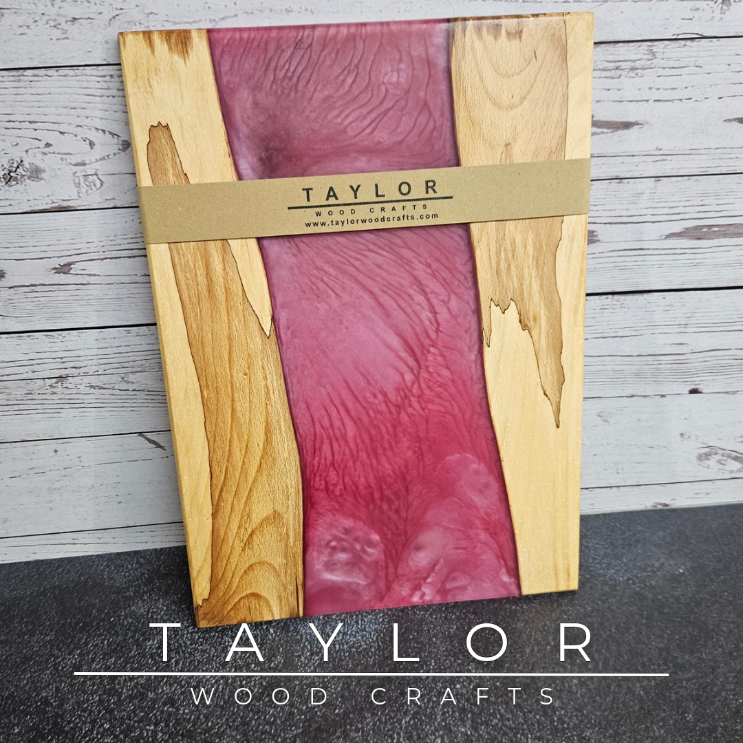 Handmade epoxy resin river charcuterie boards combining natural hardwood with striking resin designs, crafted in Northern Ireland for serving food and entertaining guests.