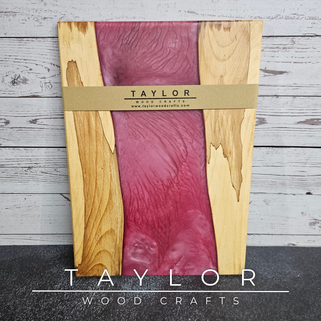 Handmade epoxy resin river charcuterie boards combining natural hardwood with striking resin designs, crafted in Northern Ireland for serving food and entertaining guests.